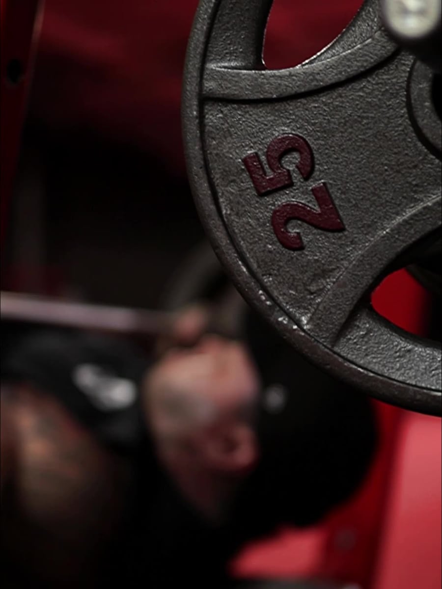 Athlete training in a red and black gym